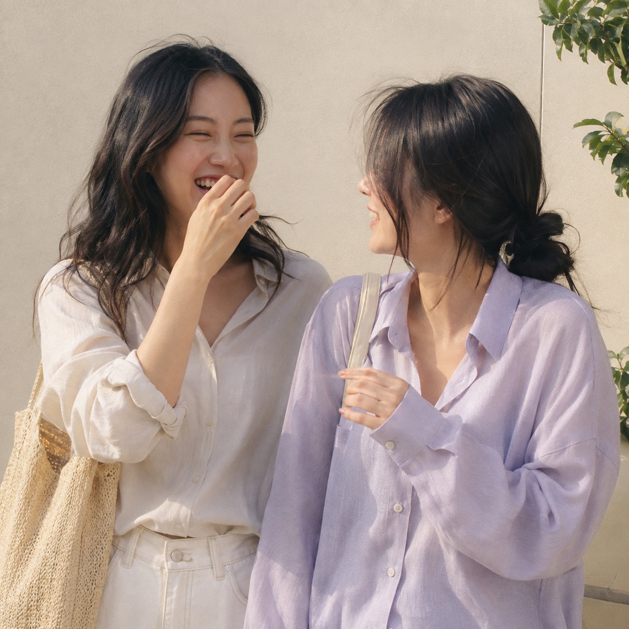 햇살 아래에서 자연스럽게 웃고 있는 여성 친구 두 명